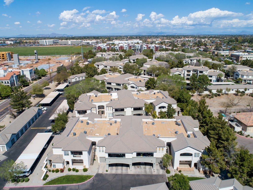 an aerial view of a large suburban neighborhood with green grass and trees